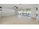 Spacious living room with light wood floors, ceiling fan, natural light, and access to a patio at 2204 78Th W St, Bradenton, FL 34209
