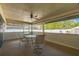 Enclosed patio with ceiling fan and seating, perfect for outdoor relaxation and entertaining at 2204 78Th W St, Bradenton, FL 34209