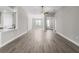 Spacious living room featuring modern wood flooring, neutral walls, and an open concept design at 2330 Hiers Rd, Dover, FL 33527