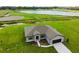 A charming single-story home boasts a well-manicured lawn and a serene lake view, creating an idyllic setting at 2402 Hiers Rd, Dover, FL 33527
