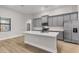 Modern kitchen with stainless appliances, center island with bar stool seating and gray cabinets at 2402 Hiers Rd, Dover, FL 33527