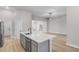 Spacious kitchen with island, stainless steel appliances, and hardwood flooring at 2402 Hiers Rd, Dover, FL 33527