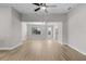 Bright living room featuring open floor plan, hard wood flooring, a ceiling fan and neutral paint at 2402 Hiers Rd, Dover, FL 33527