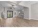 Open-concept living room flows into modern kitchen with stainless steel appliances at 2402 Hiers Rd, Dover, FL 33527