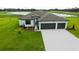 Charming single-story home with a three-car garage, and a well-manicured lawn with lake view at 2414 Hiers Rd, Dover, FL 33527