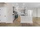 Contemporary open kitchen featuring stainless steel appliances, a peninsula with a breakfast bar, and wood floors at 2414 Hiers Rd, Dover, FL 33527
