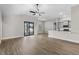 Open-concept living space featuring wood floors and a kitchen bar with grey cabinets and white countertops at 2414 Hiers Rd, Dover, FL 33527
