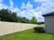 Backyard with privacy fence and green grass at 24815 Lambrusco Loop, Lutz, FL 33559