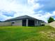 Backyard with a screened-in porch, a privacy fence, and a lush lawn at 24815 Lambrusco Loop, Lutz, FL 33559