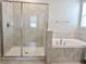 Bathroom with a walk-in shower and separate soaking tub at 24815 Lambrusco Loop, Lutz, FL 33559