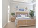 Bright bedroom featuring a rattan bed frame, coastal decor, and lots of natural light from the window at 24815 Lambrusco Loop, Lutz, FL 33559