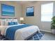 Comfortable bedroom featuring soft, neutral tones and beach-themed decorative artwork at 24815 Lambrusco Loop, Lutz, FL 33559