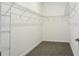 Walk-in closet with carpeted floors and metal shelving that provides lots of storage space at 24815 Lambrusco Loop, Lutz, FL 33559