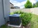 New AC unit is surrounded by shrubs at 24815 Lambrusco Loop, Lutz, FL 33559