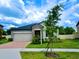 Charming single-Gathering home featuring a two-car garage, stone accents, and a well-manicured lawn at 24815 Lambrusco Loop, Lutz, FL 33559
