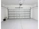 Clean, empty garage with a white floor at 24815 Lambrusco Loop, Lutz, FL 33559