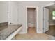 Hallway with granite counter, a bathroom and bedroom visible at 24815 Lambrusco Loop, Lutz, FL 33559