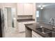 Bright, open kitchen with granite countertops, stainless steel appliances, and ample cabinet space at 24815 Lambrusco Loop, Lutz, FL 33559