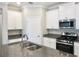Well-appointed kitchen with white cabinetry, granite countertops, and stainless steel appliances at 24815 Lambrusco Loop, Lutz, FL 33559