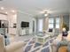 A cozy living room with ample seating, neutral tones, and lots of natural light at 24815 Lambrusco Loop, Lutz, FL 33559