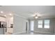 Bright, open living room features tile floors, crown molding, and access to the kitchen at 24815 Lambrusco Loop, Lutz, FL 33559