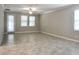 Neutral living room with tile floors, ceiling fan, and lots of natural light at 24815 Lambrusco Loop, Lutz, FL 33559