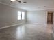 Large living room with tile floors, crown molding, and lots of natural light at 24815 Lambrusco Loop, Lutz, FL 33559