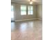 Well lit living room with tile floors and door to lanai at 24815 Lambrusco Loop, Lutz, FL 33559