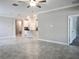 Living room with tile floors and view to kitchen and other rooms at 24815 Lambrusco Loop, Lutz, FL 33559