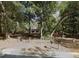 A home exterior behind a sparse fence shaded by mature trees at 25425 Olympia Rd, Brooksville, FL 34601