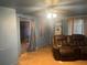 Living room with a leather couch and a ceiling fan at 25425 Olympia Rd, Brooksville, FL 34601