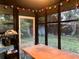 Relax on the screened-in porch with a table, shelf and whimsical string lights to bring some cheer at 25425 Olympia Rd, Brooksville, FL 34601