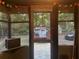 View from screened porch with string lights overlooking trees, landscape and parking area at 25425 Olympia Rd, Brooksville, FL 34601