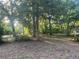 View of wooded lot with mature shade trees at 25425 Olympia Rd, Brooksville, FL 34601