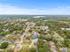 An aerial view of the property in a lush neighborhood, showcasing the home's location near lakes and green spaces at 2554 Lake Ellen Cir, Tampa, FL 33618