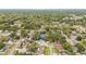 This aerial view showcases a home within a residential neighborhood dotted with mature trees, lakes and community parks at 2554 Lake Ellen Cir, Tampa, FL 33618