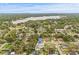 A tranquil aerial view of a charming home and neighborhood, with a lake and city skyline in the distance at 2554 Lake Ellen Cir, Tampa, FL 33618