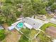 An aerial view of the property showcasing the pool, backyard, and surrounding greenery at 2554 Lake Ellen Cir, Tampa, FL 33618