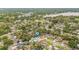 An aerial view of a neighborhood with tree-lined streets and houses, conveniently near lakes and parks at 2554 Lake Ellen Cir, Tampa, FL 33618