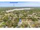 A tranquil aerial view of a charming home and neighborhood, with a lake and city skyline in the distance at 2554 Lake Ellen Cir, Tampa, FL 33618
