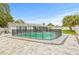 Expansive backyard featuring a sparkling pool with safety fencing and ample patio space for entertaining and relaxation at 2554 Lake Ellen Cir, Tampa, FL 33618