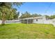 Spacious backyard featuring a pool, screened lanai, and lush lawn at 2554 Lake Ellen Cir, Tampa, FL 33618