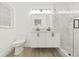 Modern bathroom features dual sinks, wood-look flooring, and a glass-enclosed shower at 2554 Lake Ellen Cir, Tampa, FL 33618