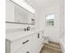 Bright bathroom featuring a white vanity, marble countertops, and updated fixtures at 2554 Lake Ellen Cir, Tampa, FL 33618