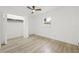 Bright bedroom featuring wood-look floors, a window, ceiling fan, and closet at 2554 Lake Ellen Cir, Tampa, FL 33618