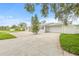White brick home showcasing a spacious driveway, attached garage, mature landscaping and fenced yard at 2554 Lake Ellen Cir, Tampa, FL 33618