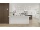 Modern kitchen with white cabinetry, stainless appliances and island with breakfast bar at 2554 Lake Ellen Cir, Tampa, FL 33618
