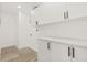 Bright laundry room featuring ample storage, counter space, and updated fixtures at 2554 Lake Ellen Cir, Tampa, FL 33618