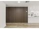 Living room featuring a wooden accent wall and open layout to the kitchen at 2554 Lake Ellen Cir, Tampa, FL 33618