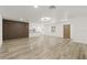Bright and spacious living room featuring light hardwood floors, modern lighting, and neutral color palette at 2554 Lake Ellen Cir, Tampa, FL 33618